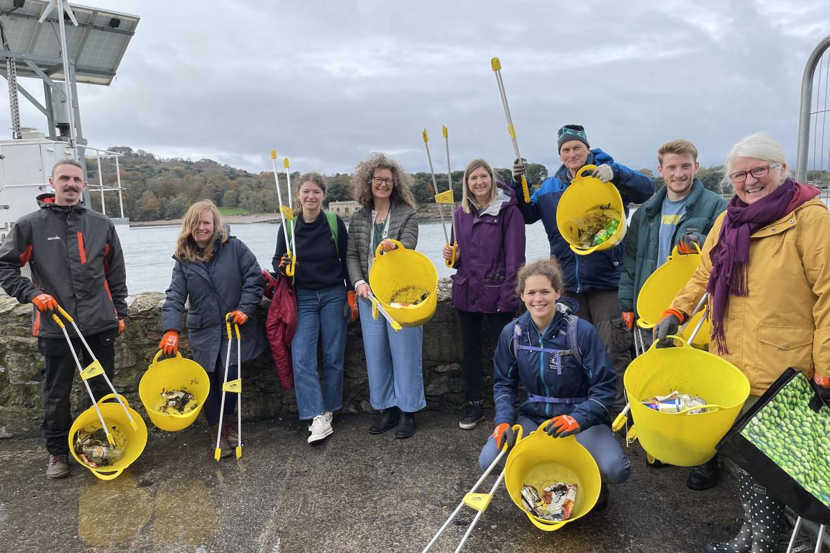 People together at the end of a beach clean - Photo credit Preventing plastic pollution