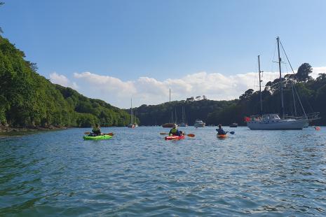 three kayakers on the Yealm Estuary on a sunny day